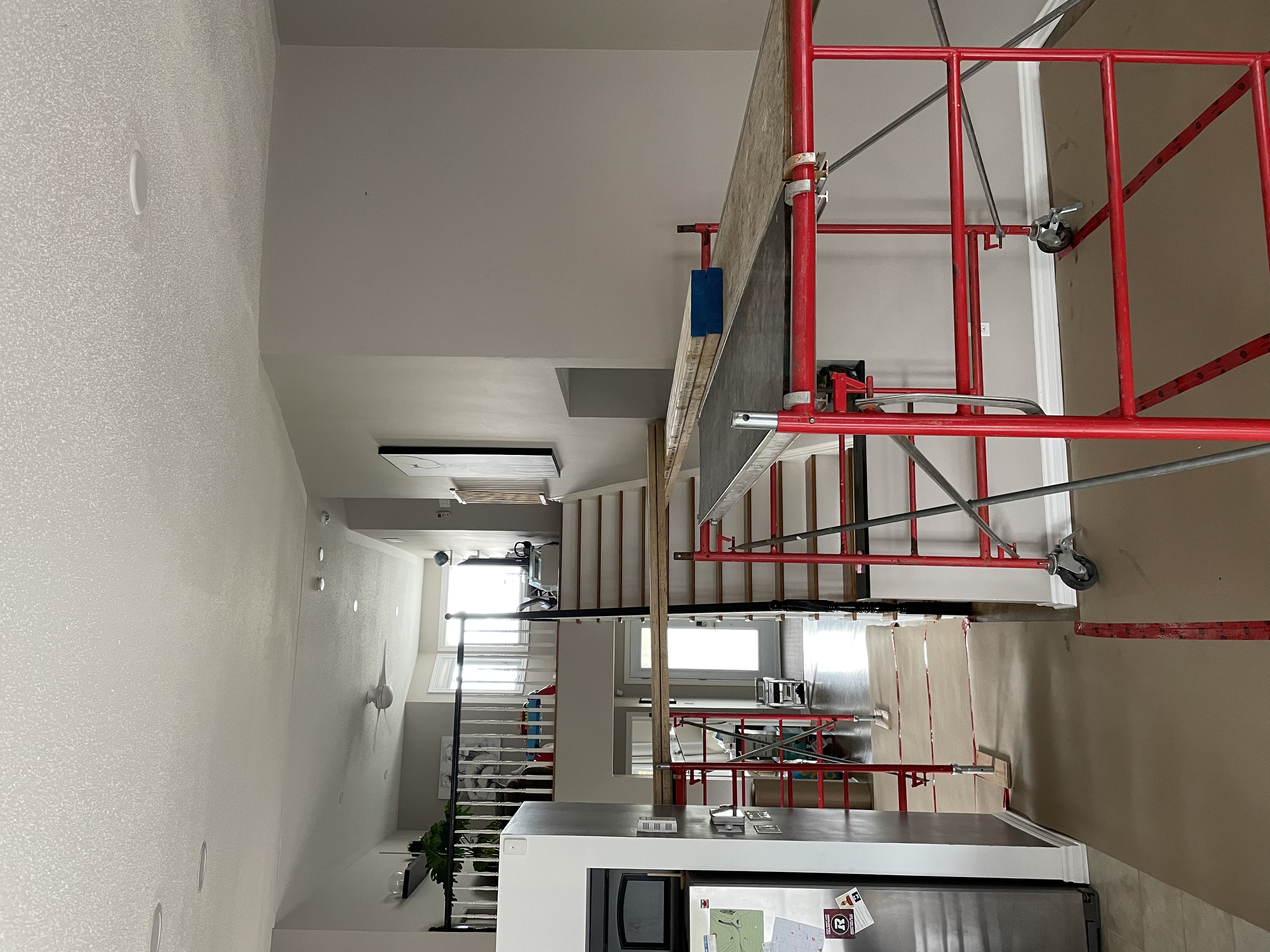 Scaffold set up during interior finishing near an open staircase